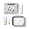 Skincare gift set featuring a gray box labeled 'Ready, Set, Discover', several white tubes with colored accents, and a clear zip pouch.