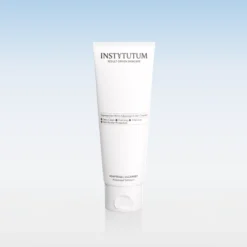 White Instytutum skincare tube (Adaptogel Cleanser) standing upright against a pale blue gradient background, product shot intended for a cleanser.
