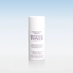 White bottle of Retinol Toner against a pale blue gradient background, product name clearly visible on the label.