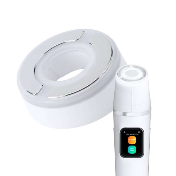 White circular docking station next to a handheld skin care device with a small color‑coded display showing Vitamin C and Skin Care options.