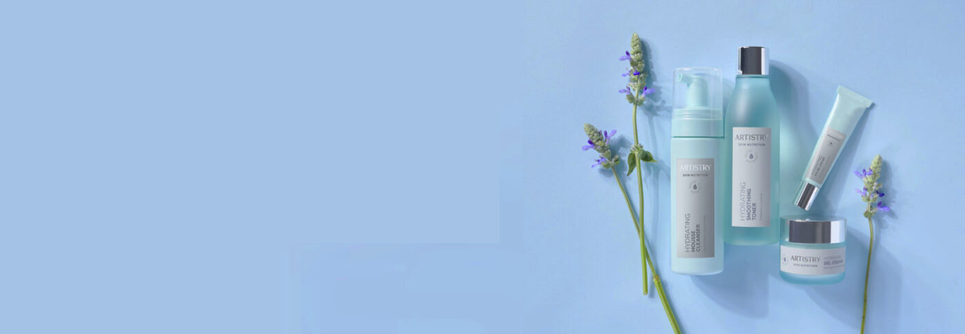 Artistry hydrating skincare set (cleanser, toner, moisturizer) arranged with lavender on a pale blue background
