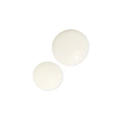 Three white round tablets arranged diagonally on a white background.