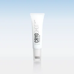 White skincare tube with vertical black branding, standing upright against a pale blue gradient background.