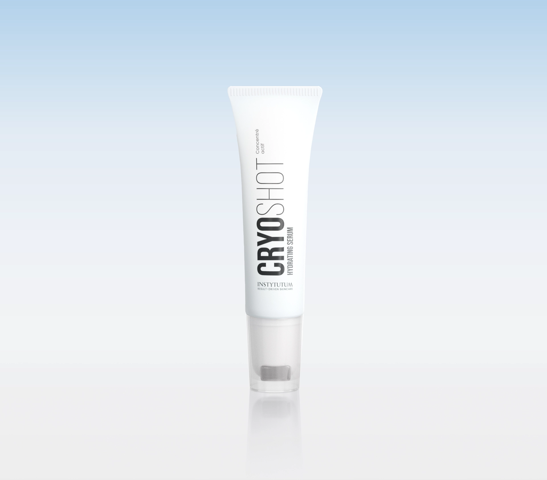 White skincare tube with vertical black branding, standing upright against a pale blue gradient background.