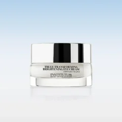 Jar of Instytutum Truly-Transforming Brightening Eye Cream with a reflective silver lid on a pale gradient backdrop.