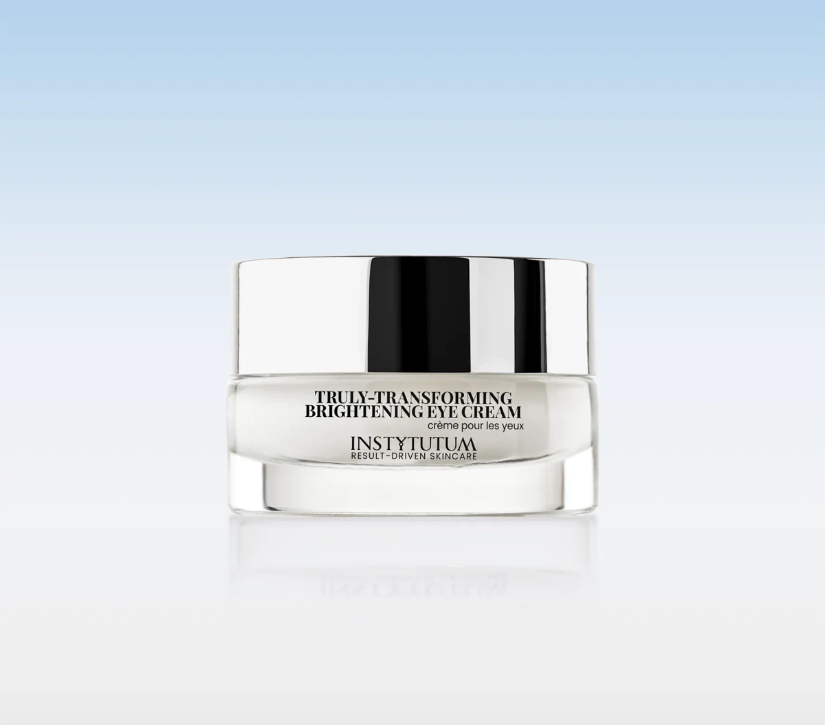Jar of Instytutum Truly-Transforming Brightening Eye Cream with a reflective silver lid on a pale gradient backdrop.