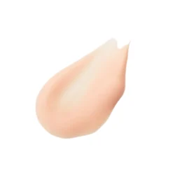 Peach-toned cream foundation swatch on white background