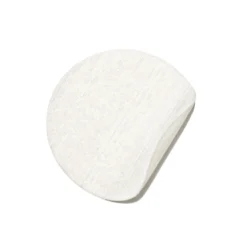 White round cotton pad used for skincare or makeup removal.