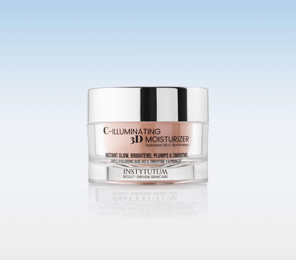 Jar of Instytutum C-Illuminating 3D Moisturizer with a reflective silver lid on a light blue gradient background, showcasing the product label