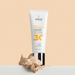 White tube of Image Skincare Daily Prevention SPF 30 moisturizer, with a swirl of beige cream in front on a pale background.