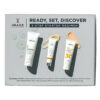 Three IMAGE skincare tubes from the 'Ready, Set, Discover' 3-step starter regimen kit laid diagonally on a gray background.