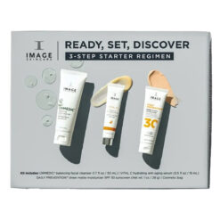 Three IMAGE skincare tubes from the 'Ready, Set, Discover' 3-step starter regimen kit laid diagonally on a gray background.