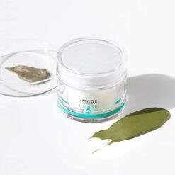 Clear jar of Image Skincare MASK with a green facial mask swatch on a white surface beside it.