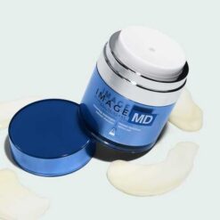 Blue jar of IMAGE MD moisturizing cream with open lid and cream swatches on a pale background.