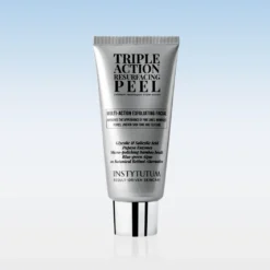 Multi-action exfoliating facial peel in a silver tube standing upright against a pale blue gradient background.