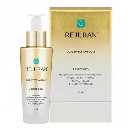 Rejuran Dual Effect Ampoule bottle beside its gold box, teal leaf logo visible.