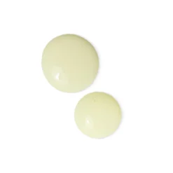 Two pale yellow round tablets with glossy surfaces on a white background.
