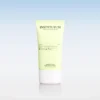Instytutum sunscreen tube with SPF50, pale yellow container and white cap, on a reflective surface against a blue gradient background.