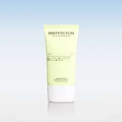 Instytutum sunscreen tube with SPF50, pale yellow container and white cap, on a reflective surface against a blue gradient background.