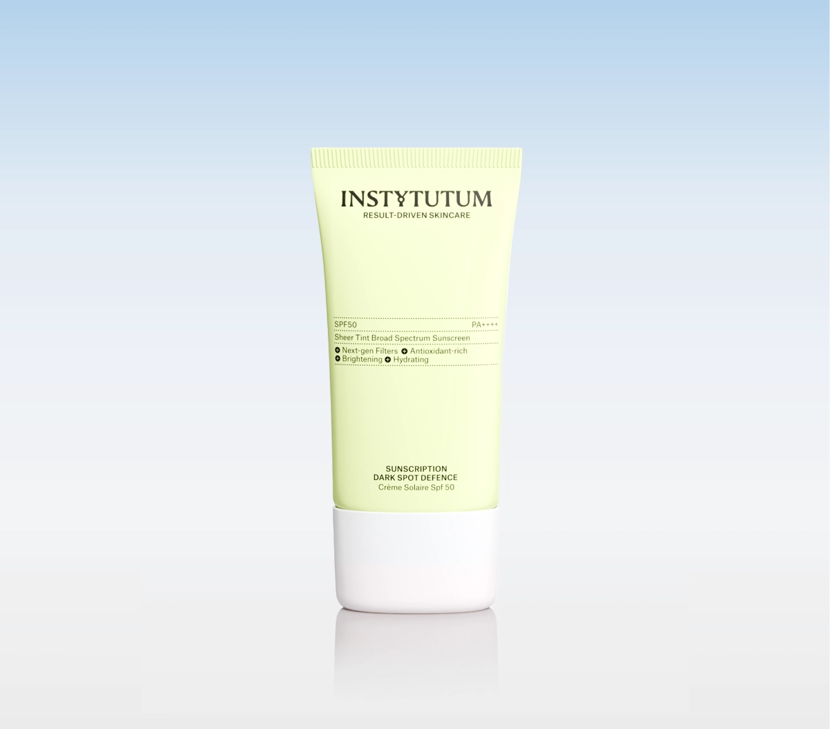 Instytutum sunscreen tube with SPF50, pale yellow container and white cap, on a reflective surface against a blue gradient background.