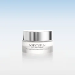 Silver-capped jar of Instytutum Truly-Transforming Brightening Eye Cream on a white reflective surface