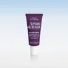 Purple retinol anti-aging serum tube standing upright on a white reflective surface, label shows '8% Retinoid Complex' and 'RETINOL' text.