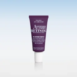 Purple retinol anti-aging serum tube standing upright on a white reflective surface, label shows '8% Retinoid Complex' and 'RETINOL' text.